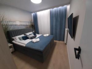 Łóżko lub łóżka w pokoju w obiekcie Apartamenty Marzeń