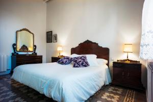 a bedroom with a bed with two dressers and a mirror at Cal Peó B&B Cardedeu in Cardedeu +8 photos