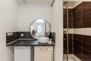 a bathroom with a sink and a mirror at Hotel l'Hotera in Cannes