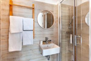 a bathroom with a sink and a shower at Hotel l'Hotera in Cannes