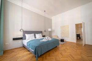 a bedroom with a large bed with a blue blanket at Joseph I levestate in Vienna