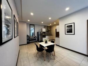a kitchen and dining room with a table and chairs at DREAMFIELD NEST at SKYNEST APARTMENTS in Nairobi
