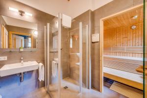 a bathroom with a sink and a shower at Chaletdorf am Sonnenhang in Neukirchen am Großvenediger