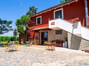 a group of chairs and tables in front of a building at Masseria Brica Rossa in Thurio