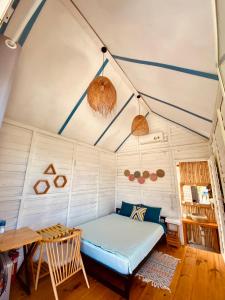 a bedroom in a tent with a bed and a table at Phan rang kite center in Thôn Dư Khánh