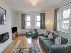 a living room with a couch and a table at Bluewater View in Saltburn-by-the-Sea