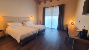 A bed or beds in a room at ORIZZONTI Vigneti Repetto