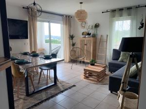a living room with a table and a couch at Bayonne Appartement terrasse 4 km plage in Bayonne
