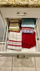 a drawer with several folded towels on a shelf at lovely 2BED 2BA vacation rental near the Beach in Pompano Beach