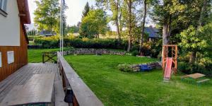 a view of a yard with a group of chairs at Chalupa Granát in Kořenov +41 photos
