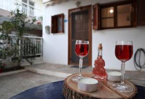 two glasses of red wine sitting on a table at Sophie's traditional hospitality appartment in Monemvasia