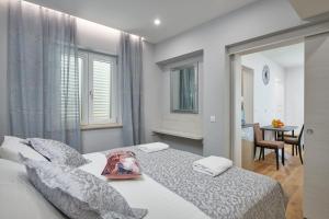 a bedroom with a bed with a bag on it at Newly renovated apt. near to entrance to Old Town in Dubrovnik