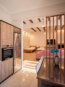 a kitchen and living room with a couch and a refrigerator at Kellys cozy one bedroom house next to the beach in Oikonomiánika