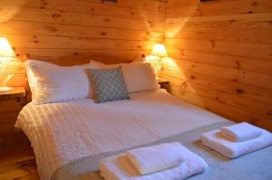 a bedroom with a bed with two towels on it at Seillean Trang in Saasaig