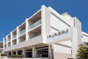 a white building with a namm sign on it at Hotel Galaxias in Rhodes Town