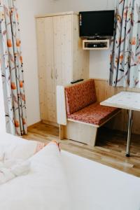 a room with a bed and a tv and a couch at Apartment Ferienglück by Interhome in Arriach
