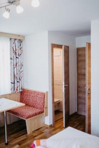a room with a bench and a table and a door at Apartment Ferienglück by Interhome in Arriach