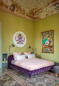 a bedroom with a large bed in a green wall at Castle Elvira in Trepuzzi