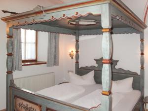an old canopy bed in a bedroom with white pillows at Apartment Burg Biedenegg- Potzner - FIE203 by Interhome in Fliess