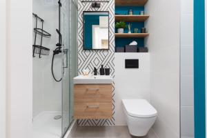 a bathroom with a shower and a toilet and a sink at Warsaw Center Capitol Apartment by Renters in Warsaw