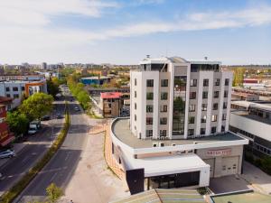 an aerial view of a city with a white building at Hotel Verticalplus in Haskovo