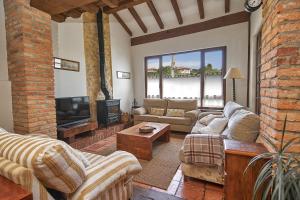 a living room with couches and a flat screen tv at Casa Taté in Trasvia