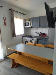 a kitchen with a table and a counter top at Appart terrasse Superdevoluy in Le Dévoluy