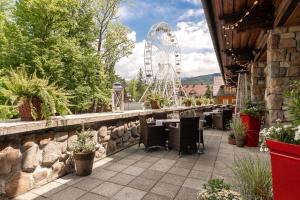 a resort patio with a ferris wheel in the background at Aries Hotel & SPA Zakopane in Zakopane