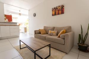 a living room with a couch and a coffee table at Place de la Cathédrale de Pointe à Pitre in Pointe-à-Pitre