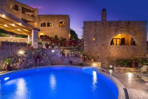 a large swimming pool in front of a building at Samonas - Orange villa Diktamos in Khiliomoudhoú