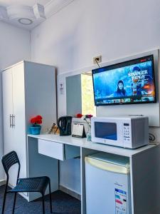 an office with a desk with a microwave and a tv at Full panorama Jerash (PLUS) in Jerash