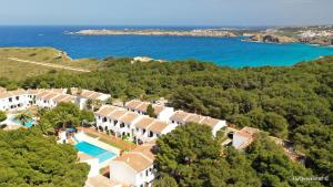 an aerial view of a house and the ocean at Playa Parc Apartments in Son Parc