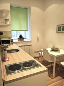 a kitchen with a stove and a table with chairs at Charming Apartment Tanja in Zagreb