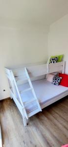 a white bunk bed with a ladder in a room at Bobiska Djenovici in Đenovići