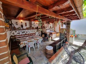 a patio with a table and chairs and a fireplace at Kaloyanova House Bansko in Bansko