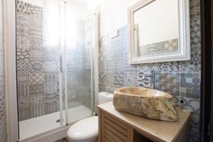 a bathroom with a sink and a shower and a toilet at Hotel La Terrasse in Zonza +40 photos