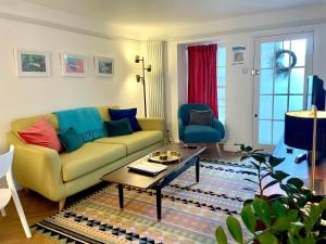 a living room with a couch and a coffee table at Ilfracombe Townhouse: restored historic home in Ilfracombe