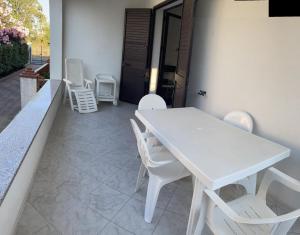 a white table and white chairs on a patio at Bilo Lu Rattali in San Teodoro