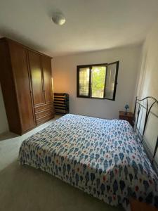 a bedroom with a bed with a blue comforter at Bilo Lu Rattali in San Teodoro