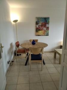 a table and chairs in a room with a lamp at Sainte Rosalie in Cannes