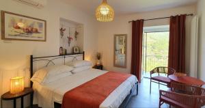 a bedroom with a bed and a table and a window at Arbanella in Corniglia