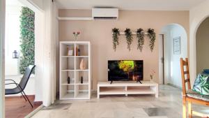 a living room with a tv and a fireplace at Laguna Beach Paradise - Alojamientos La Torre in Torrox Costa +33 photos