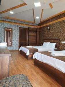 a hotel room with two beds in it at Hotel LU-MA in Tbilisi City