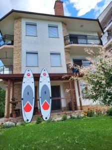 two surfboards are standing in front of a house at Vila Sara in Ohrid