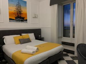a bedroom with a large bed with yellow and white pillows at Hotel Stabia in Castellammare di Stabia