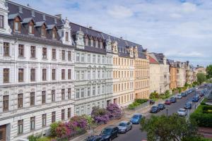 a city street with cars parked in front of buildings at Stilvolle FeWo Augusta II in Görlitz