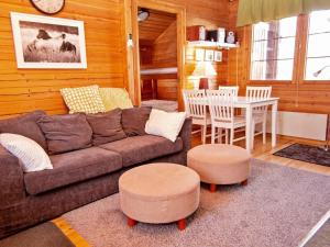 a living room with a couch and a table at Holiday Home Lomasyväri 810 by Interhome in Nilsiä