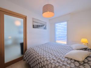 une chambre avec un lit et une grande fenêtre dans l'établissement Apartment L'Hippocampe T2 balcon by Interhome, à Les Sables-dʼOlonne