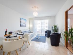 un salon avec un canapé et une table dans l'établissement Apartment L'Hippocampe T2 balcon by Interhome, à Les Sables-dʼOlonne