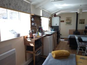 a kitchen with a sink and a counter top at Thyme Cottage in Whitby